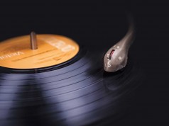 Spotify Dominates Poll As Most Popular Music Tool Vinyl record close-up showing the stylus and the rings of the vinyl record shimmering in the light.