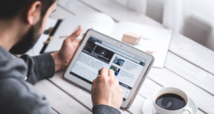 How do I get my website to the top of Google? Man using the internet on a computer tablet