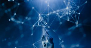 How A.I. is changing the Contact Centre Industry An abstract imagerepresenting Artificial Intelligence. A dark blue gradient that seems like it could be underwater with lots of nodes and interconnecting lines along witth a robotic hand reaching up from the bottom and pointing into the nodes.